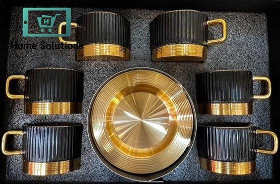 Set of black and gold coffee mugs and a bowl in a box