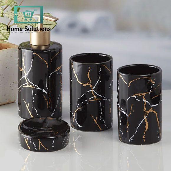 Black marble-patterned bathroom set with a pump bottle, two cups, and a container on a light surface.