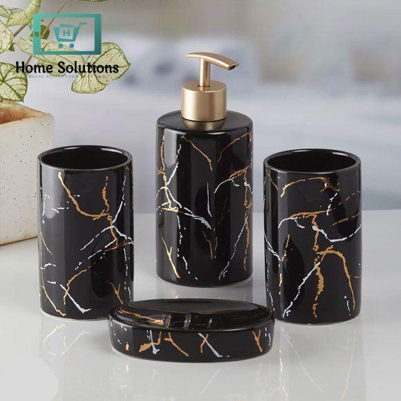 Black marble-patterned bathroom set with gold accents on a white surface.