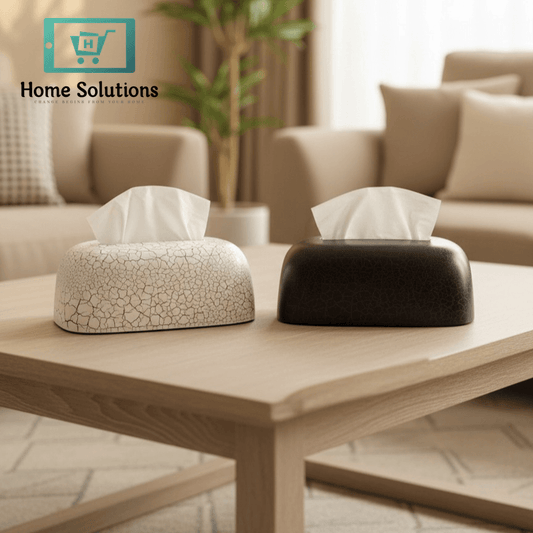 Two tissue boxes on a wooden coffee table in a living room setting.