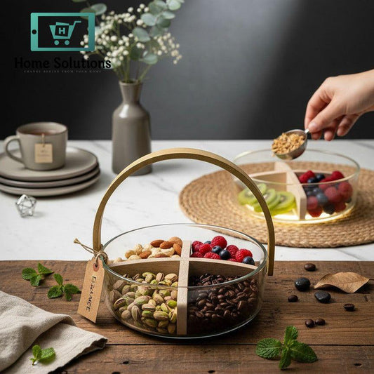 Glass snack basket with dried fruits and nuts on a wooden board, with a hand holding a spoon over a glass bowl of berries.