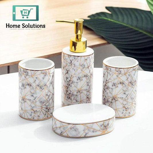 Bathroom accessory set with marble pattern and gold accents on a white surface.