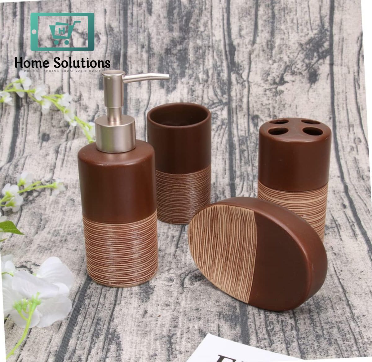 Brown bathroom accessory set with dispenser, cups, and soap dish on a textured surface.