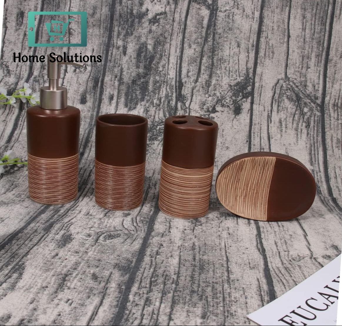 Set of brown and wooden bathroom accessories on a textured surface with 'Home Solutions' branding.