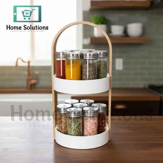 Wooden two-tier spice rack for Pakistani kitchen with 12 glass jars and stainless steel lids, showing modern countertop organization.

