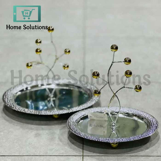 Two decorative mirrored trays with decorative branches on a light gray background, branded 'Home Solutions'.