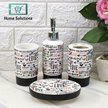 Bathroom accessory set with 'Love' and heart designs on a white surface.