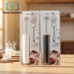 Two milk frothers in packaging on a kitchen counter with coffee and cake in the background.