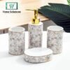 Bathroom accessory set with marble pattern and gold accents on a white surface.