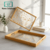 Decorative tray with gold leaf design on a marble surface