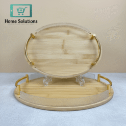 Bamboo tray with gold rim on a light gray surface against a beige background