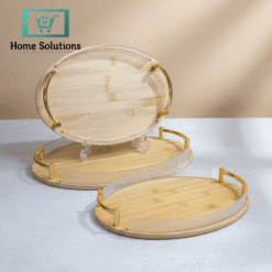 Two wooden trays with gold accents on a light gray surface with a beige background