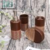 Brown bathroom accessory set with dispenser, cups, and soap dish on a textured surface.