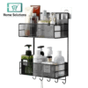 Black mesh wall-mounted storage caddy with bathroom products on a white background, featuring 'Home Solutions' branding.