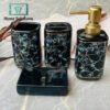 Bathroom accessory set with black marble pattern on a gray surface