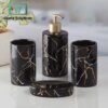 Marble Design Bath Accessories Set of 4 1 Black marble-patterned bathroom set with gold accents on a white surface.