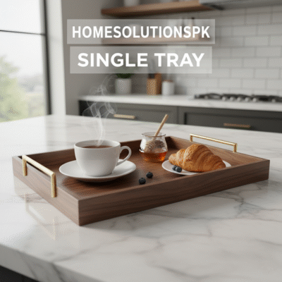 Homesolutionspk Single Tray. A rectangular dark wooden serving tray with elegant brass handles, holding a steaming white teacup, a jar of honey, blueberries, and a golden croissant on a white marble kitchen counter.