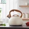 White stainless steel tea kettle with ergonomic handle and whistling spout