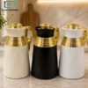 Luxury Vacuum Thermos Flask 1.0L with Gold Handle 1 Luxurya 1.0L Vacuum Thermos Flask with Matte Black and Ivory White Finish, Gold Handle and Decorative Gold Panel